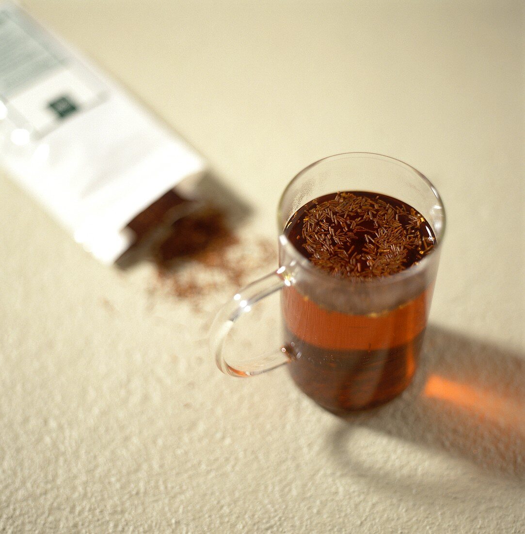 Rooibos tea in packet and brewed in glass