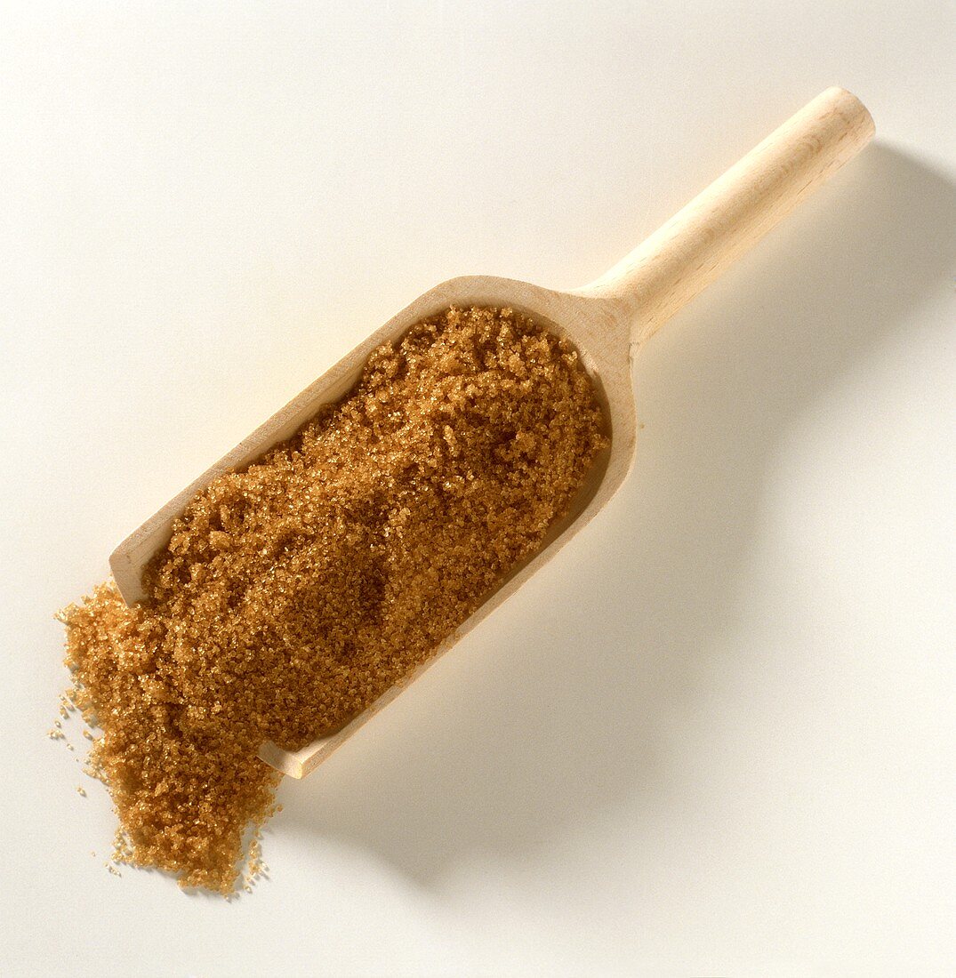 Brown sugar on wooden scoop