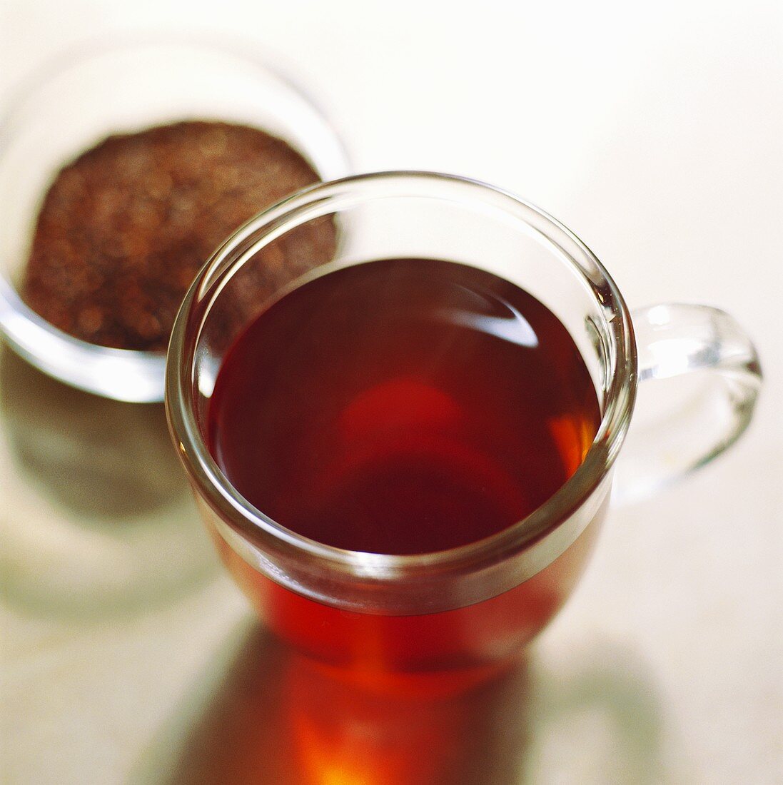 Rooibos tea in glass and unused in bowl