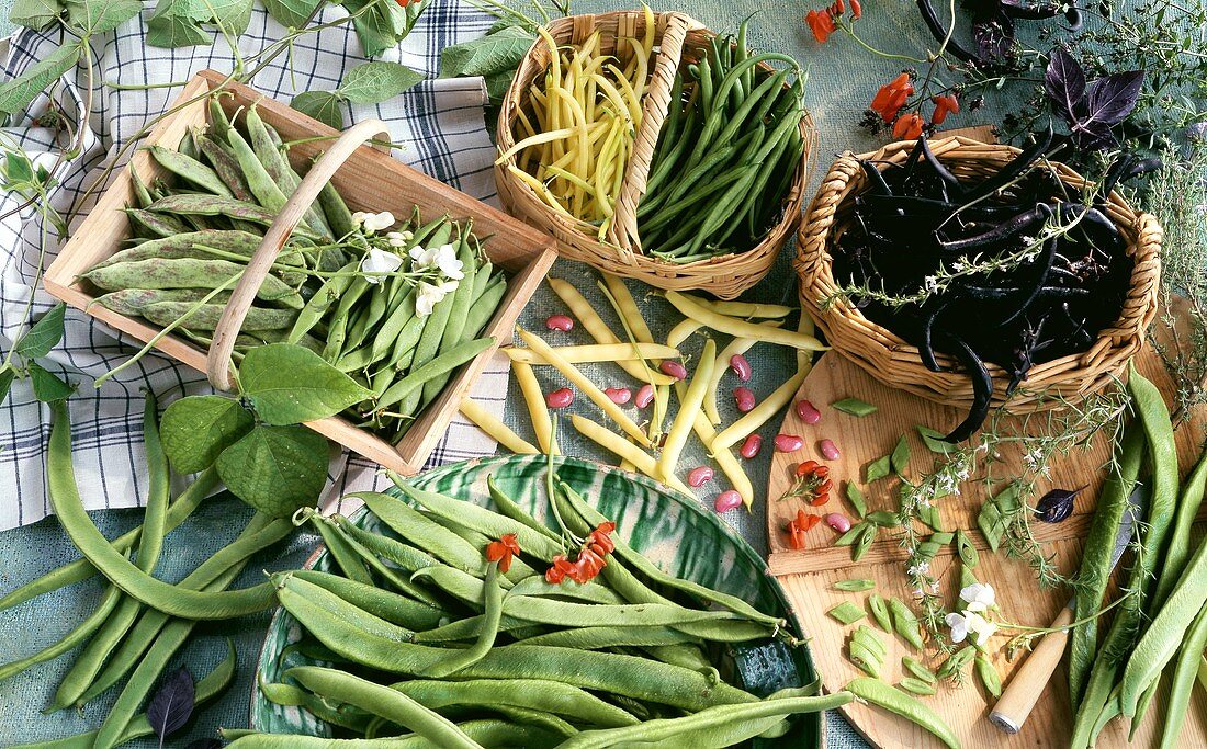 Various types of beans in baskets and bowls