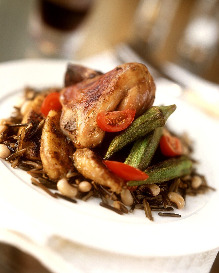 Roast chicken on wild rice, tomatoes and okra pods
