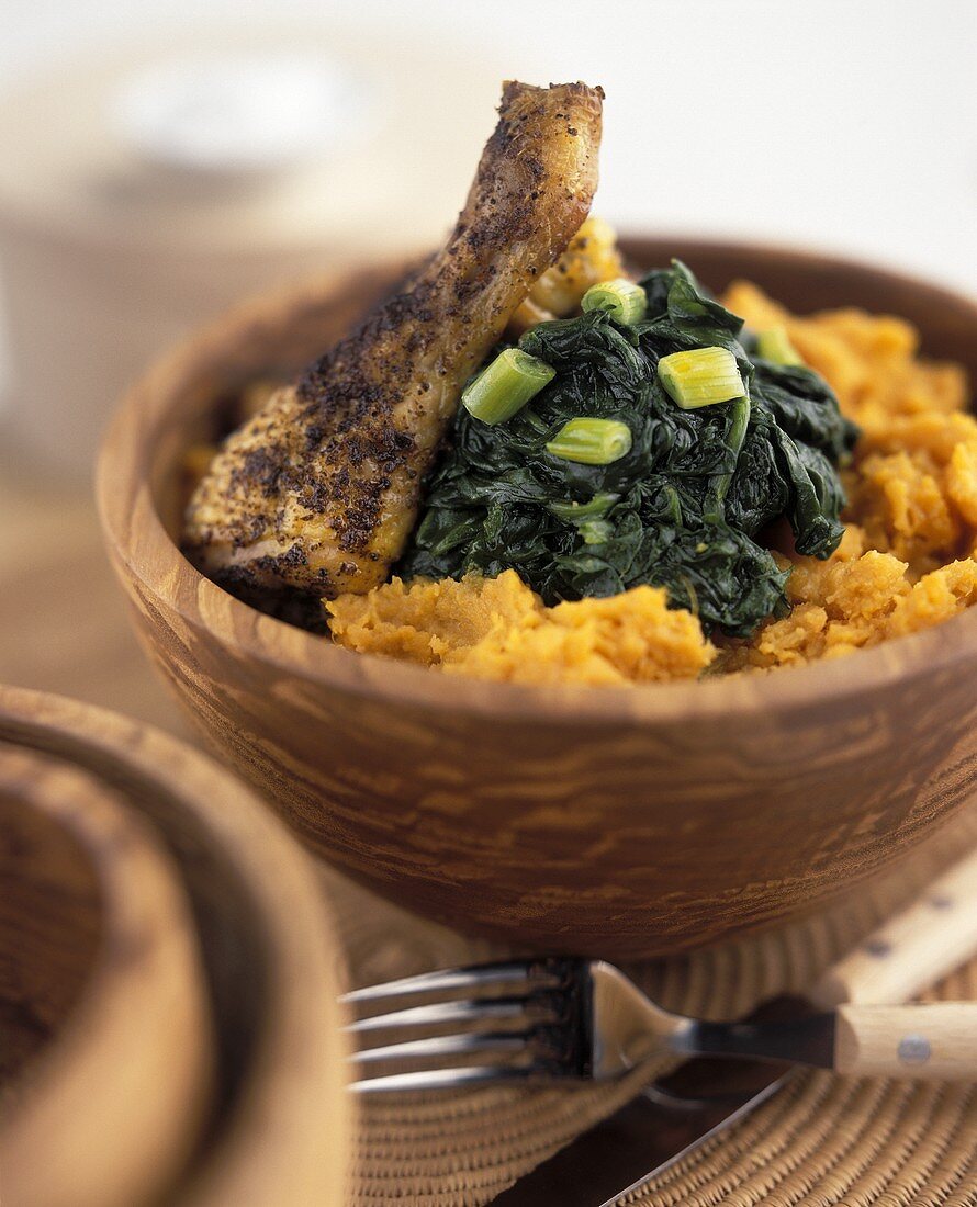 Chicken with spinach & sweet potato puree in wooden bowl