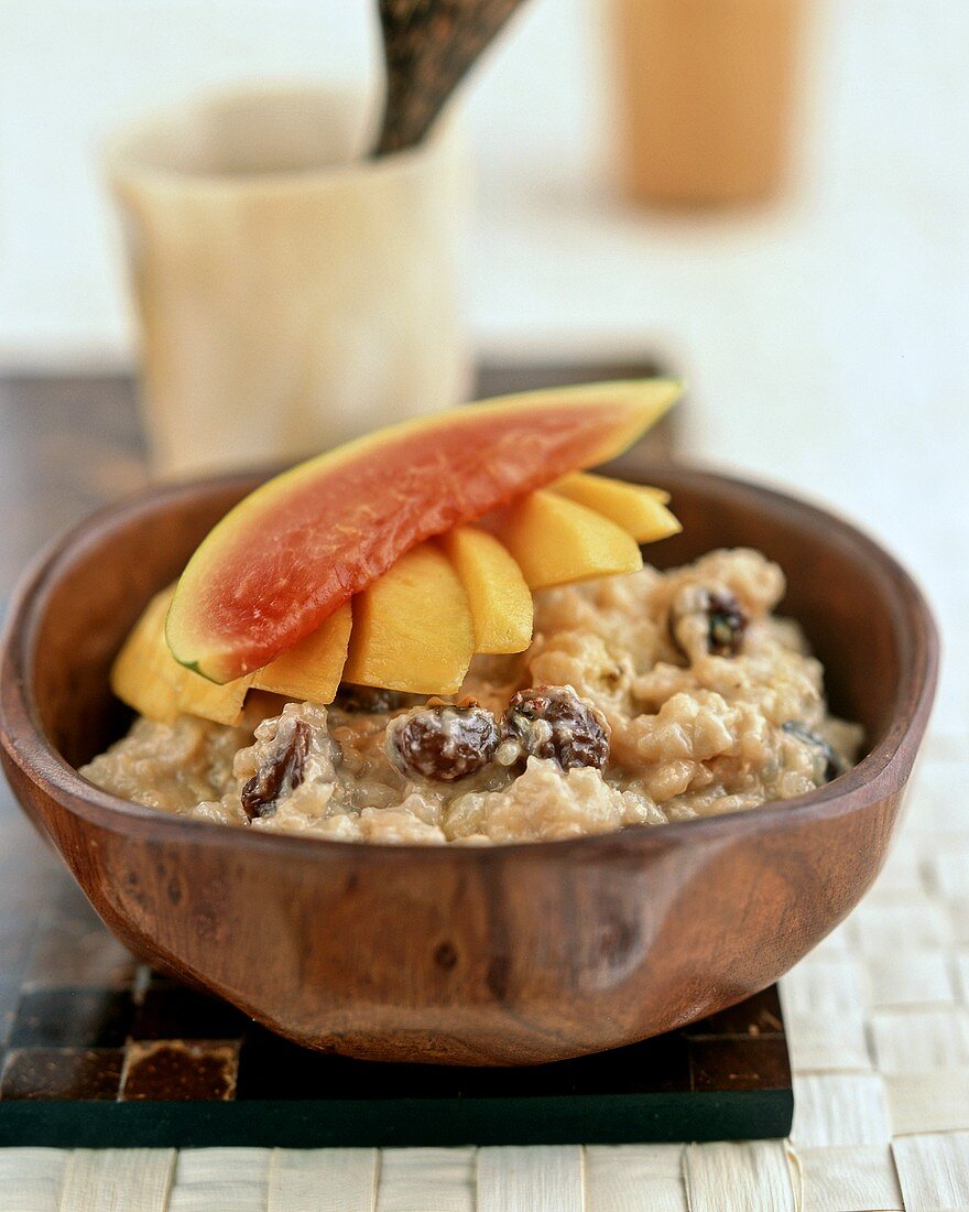 Rice pudding with bananas, mango, papaya and raisins