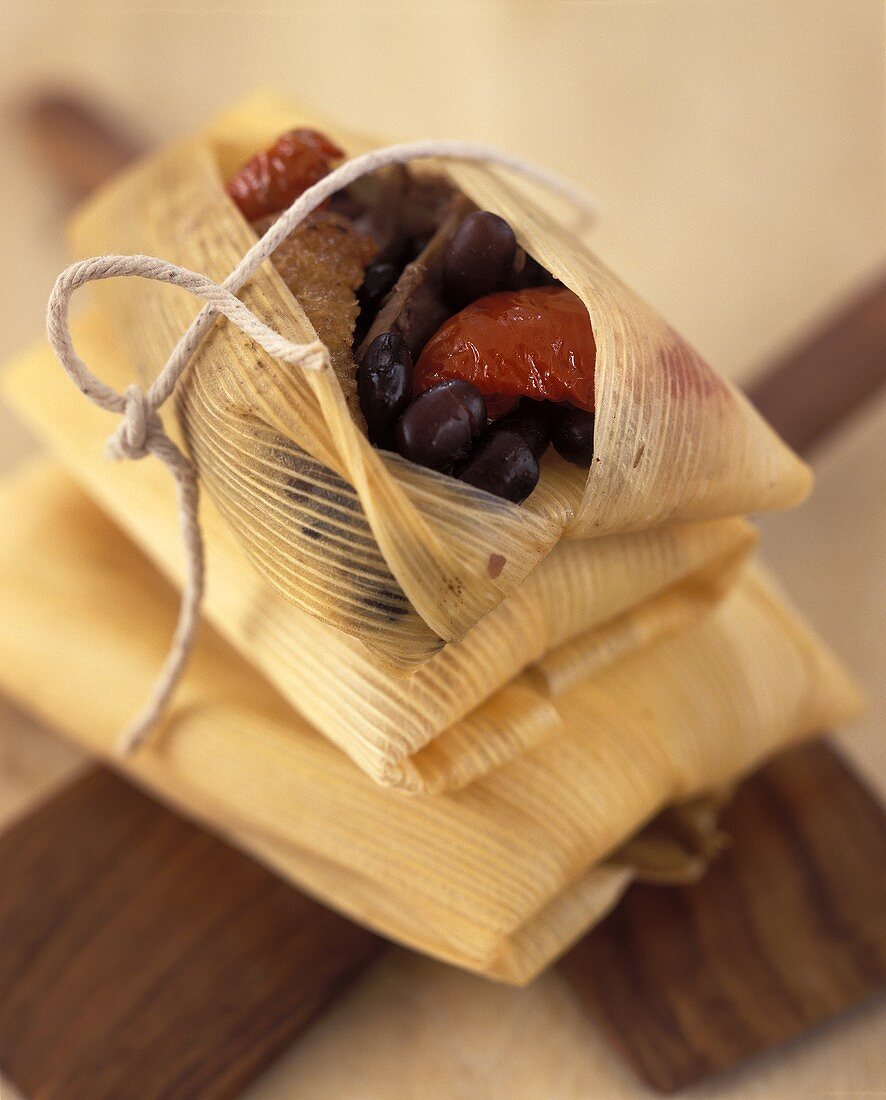 Tamales (maize leaves stuffed with duck breast & tomatoes)