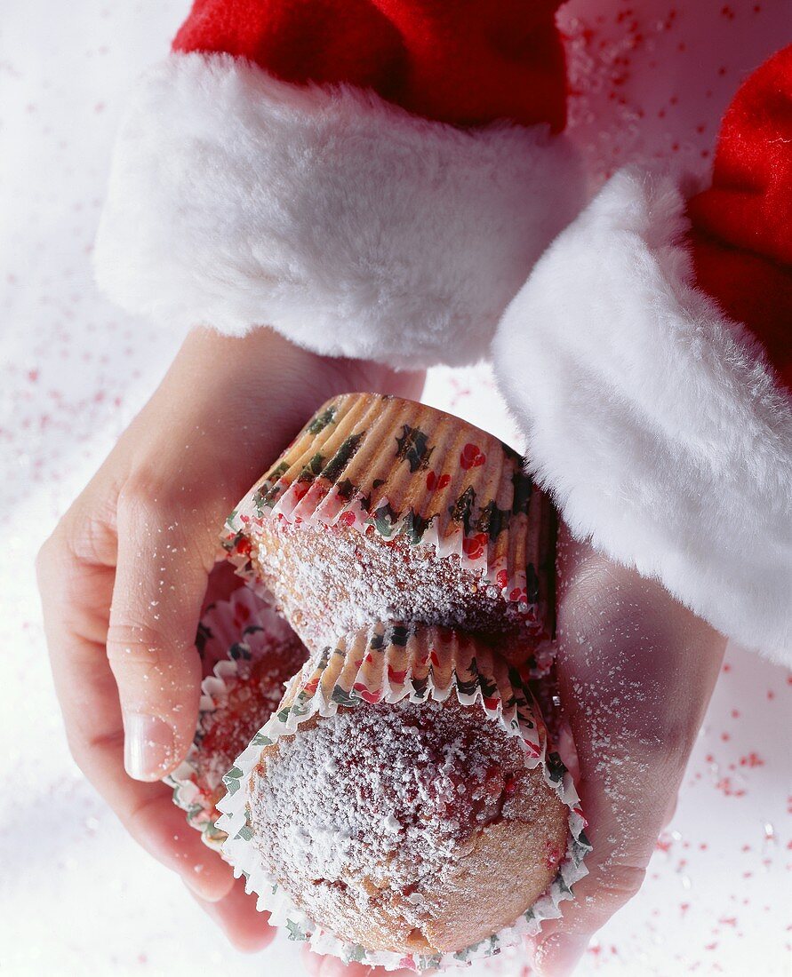 Hands Holding Cinnamon Muffins for Christmas