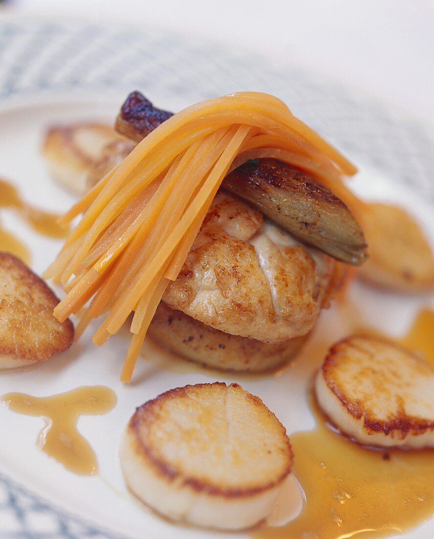 Monkfish medallions in artichoke bottoms with carrot strips