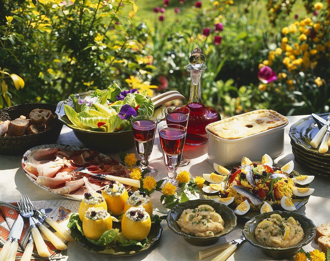 Buffet with various dishes on garden table