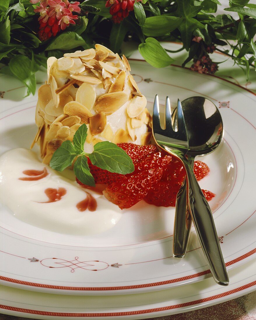Timbale with flaked almonds, strawberry sauce & vanilla sauce