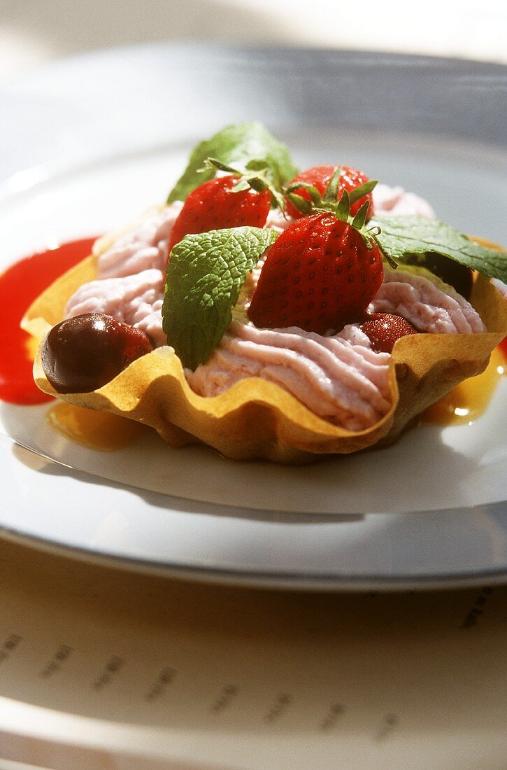 Strawberry mousse with fresh berries in wafer bowl