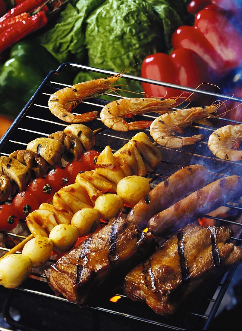 Vegetables, meat and shrimps on the grill