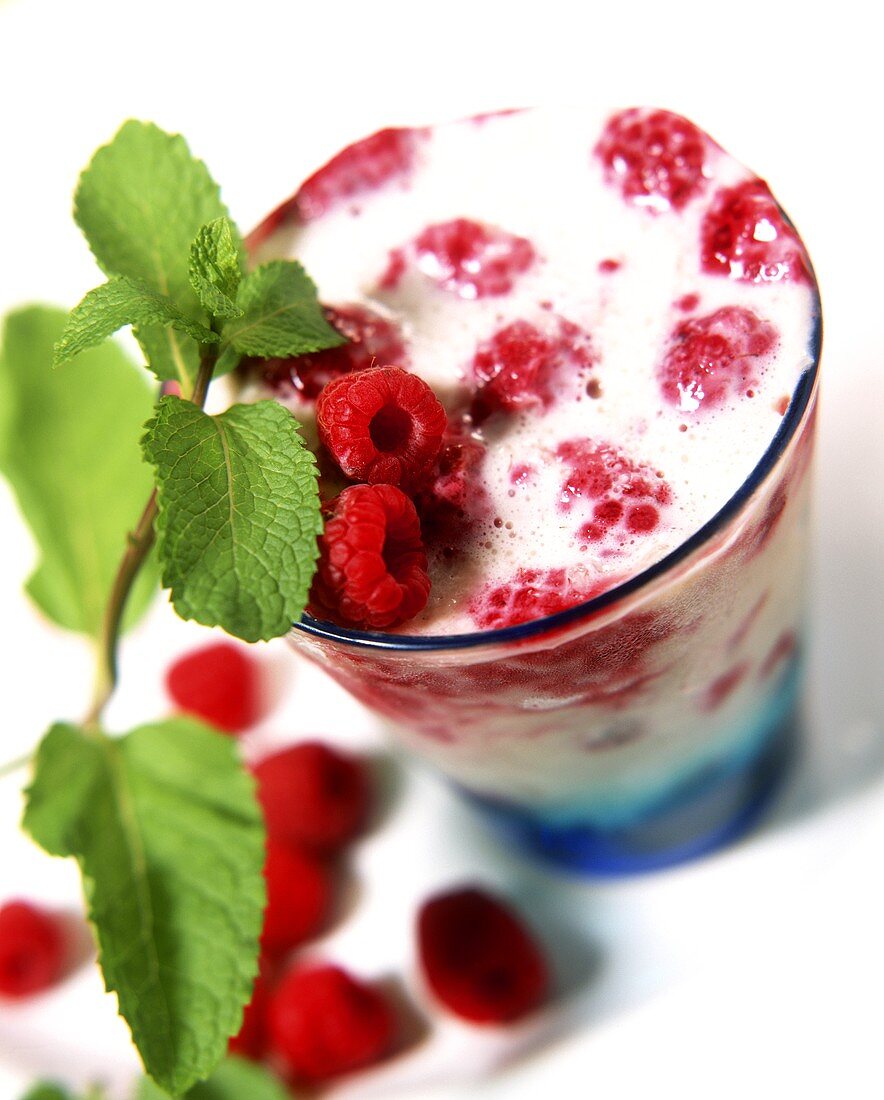 Milk shake with raspberries in a glass