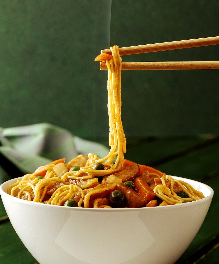 Chop suey in bowl and chopsticks