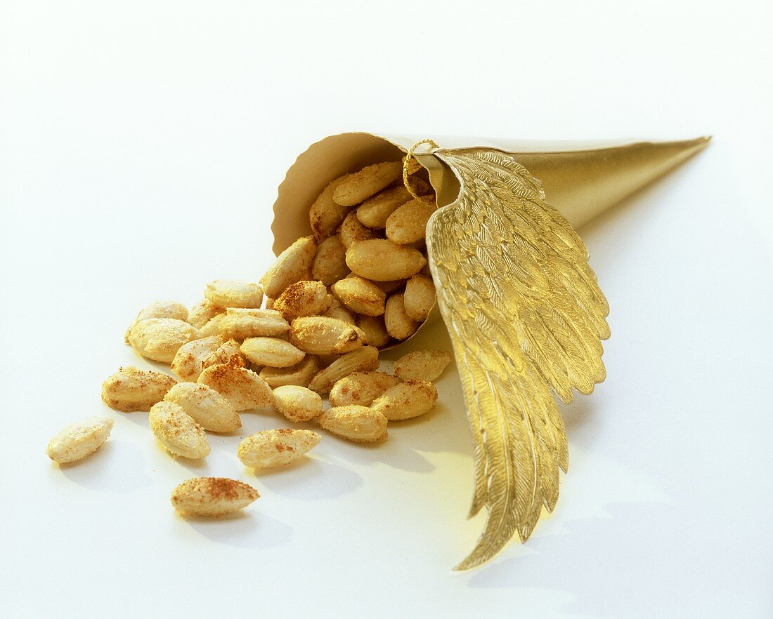 Salted almonds falling out of golden bag
