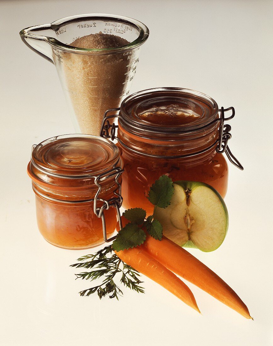 Apple & carrot jelly in jars, sugar behind