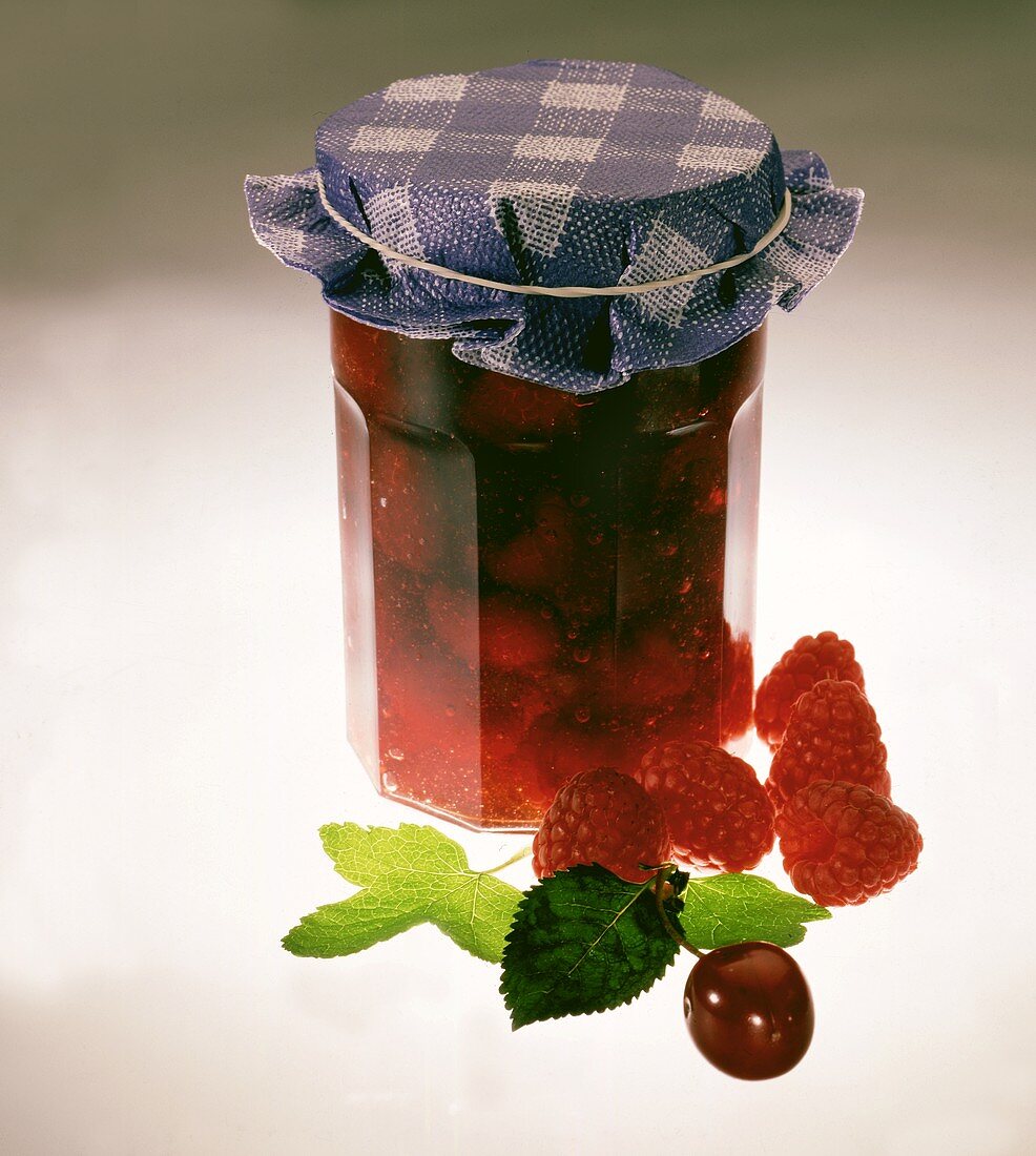 Raspberry and cherry jelly in preserving jar