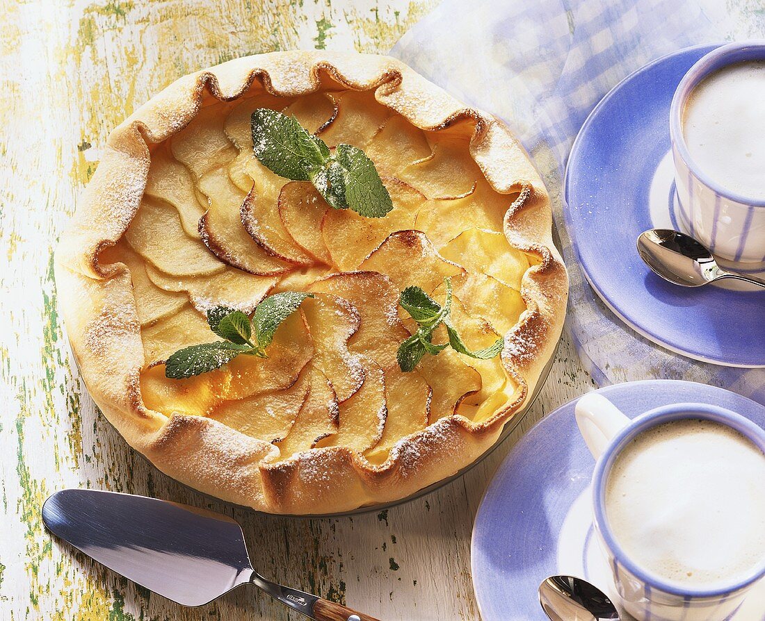 Apple tart with mint leaves, with cappuccino