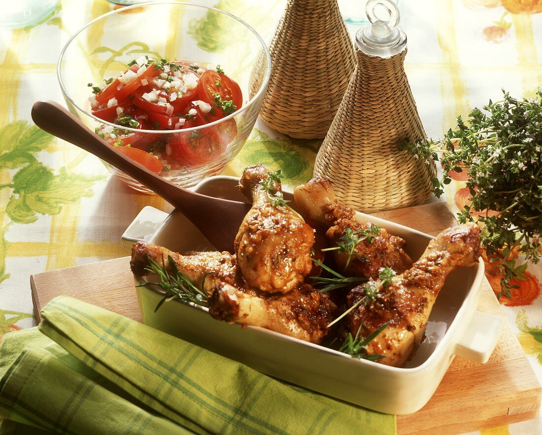 Marinated chicken legs with rosemary, with tomato salad
