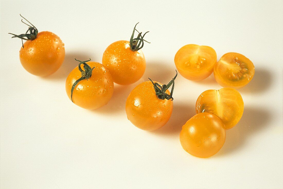 Yellow tomatoes, some sliced