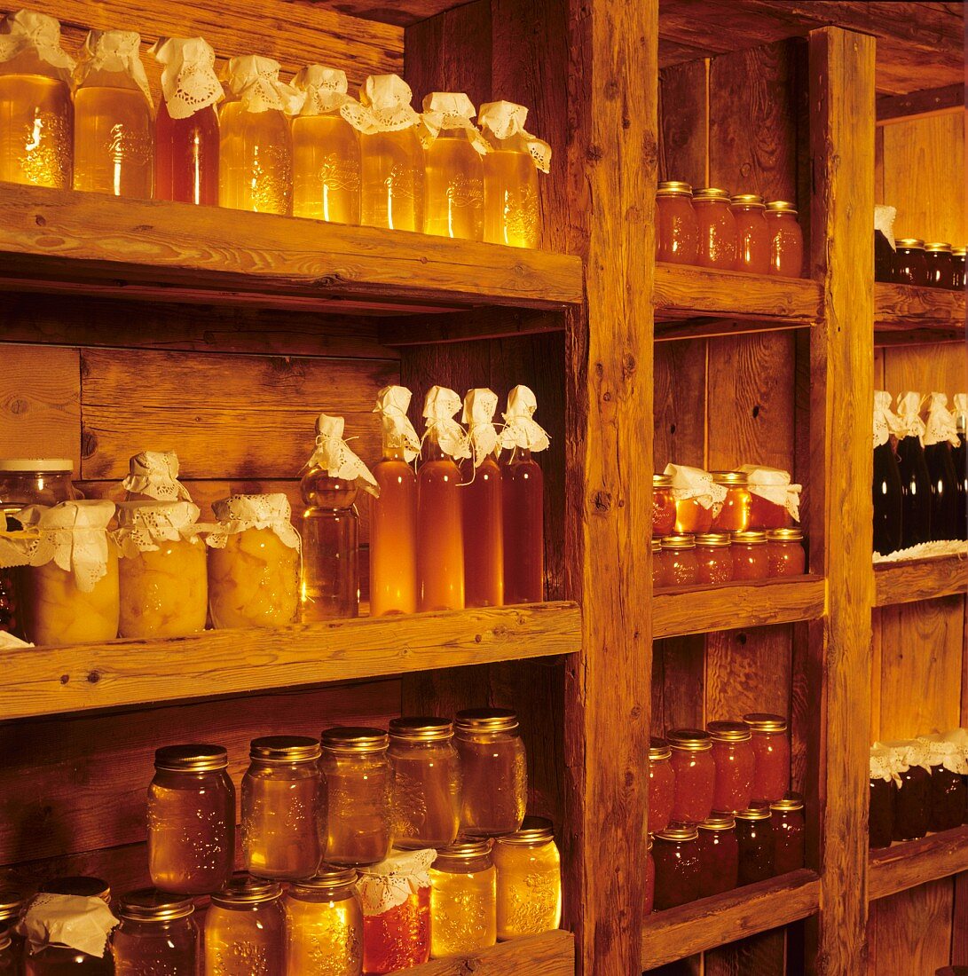 Various types of honey on wooden shelf