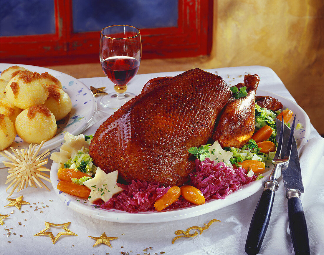 Crispy Christmas goose on vegetable platter