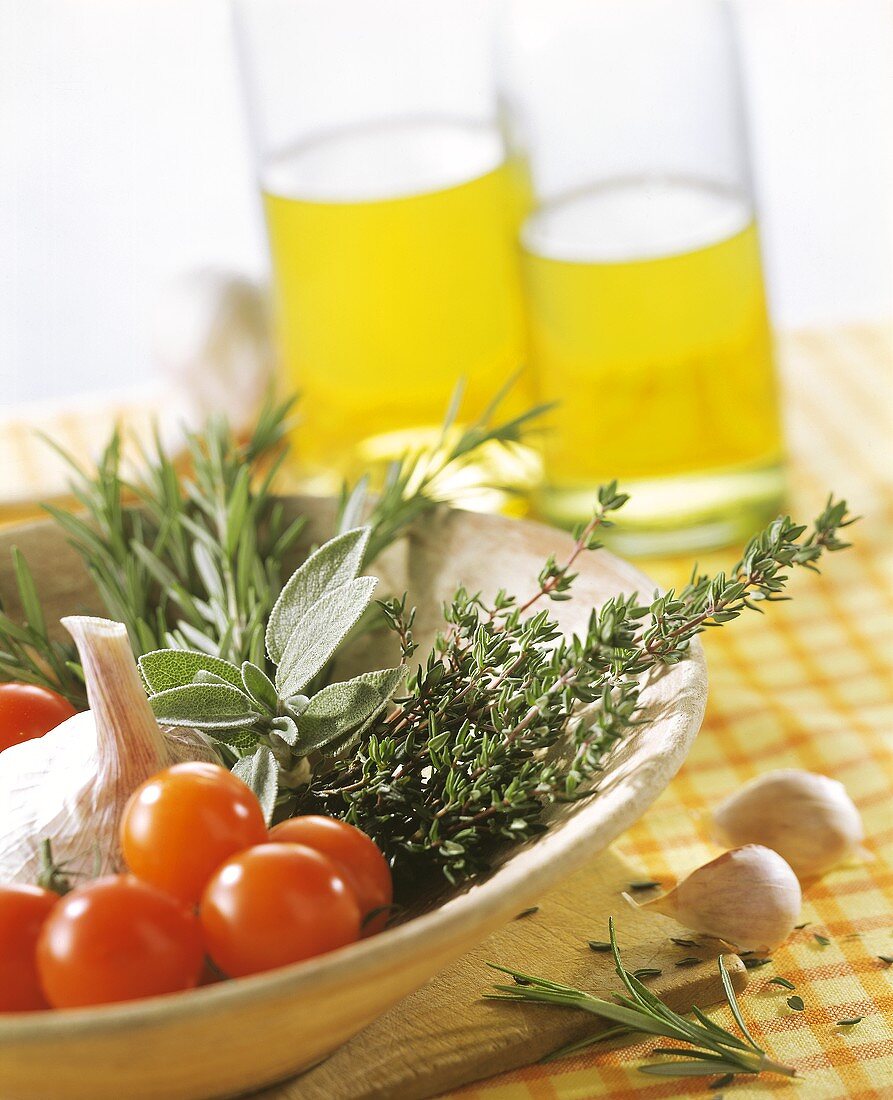 Still life with tomatoes, garlic and various herbs