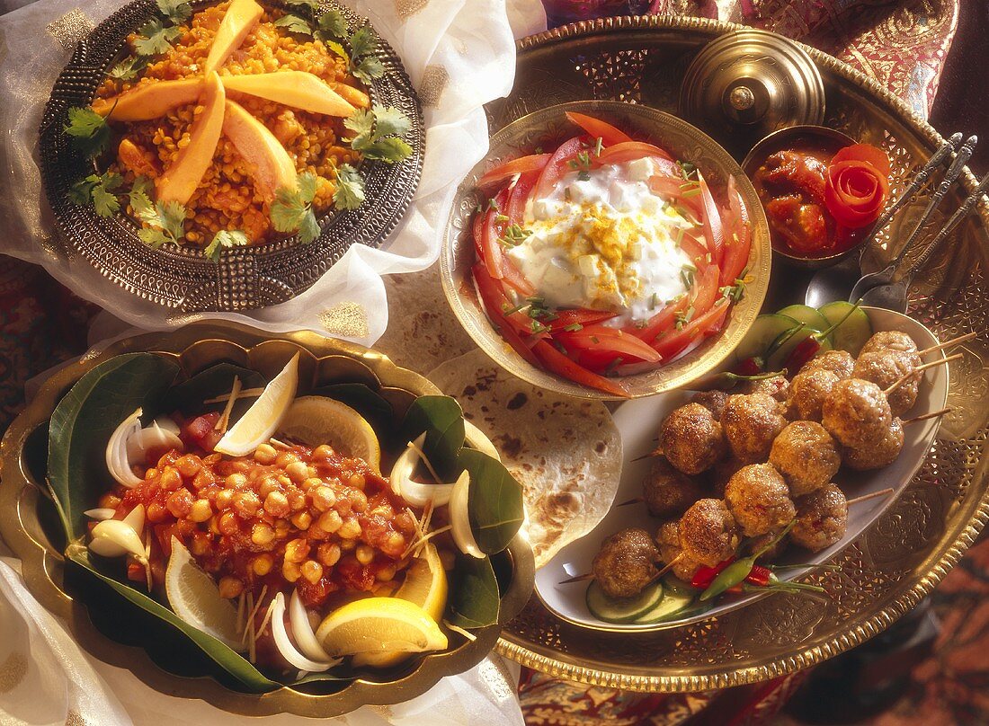 Indian table with kebabs, raita, chick peas & lentils