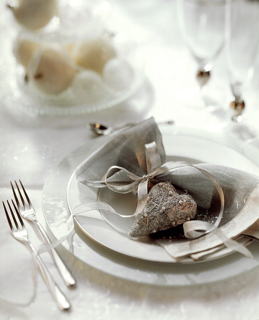 Festive table setting with a silver heart