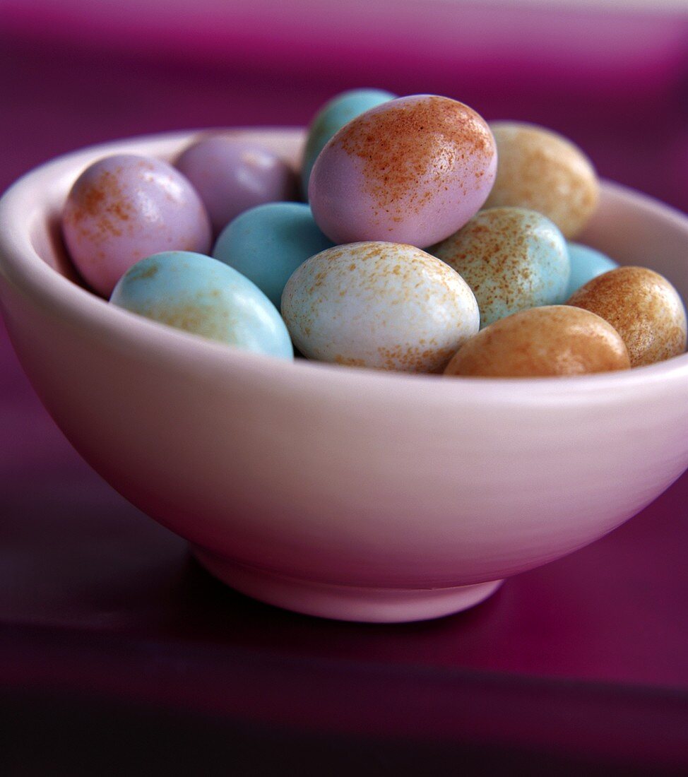 Colourful eggs in a white bowl