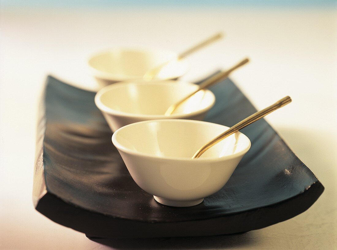 White Asian bowl on black serving platter
