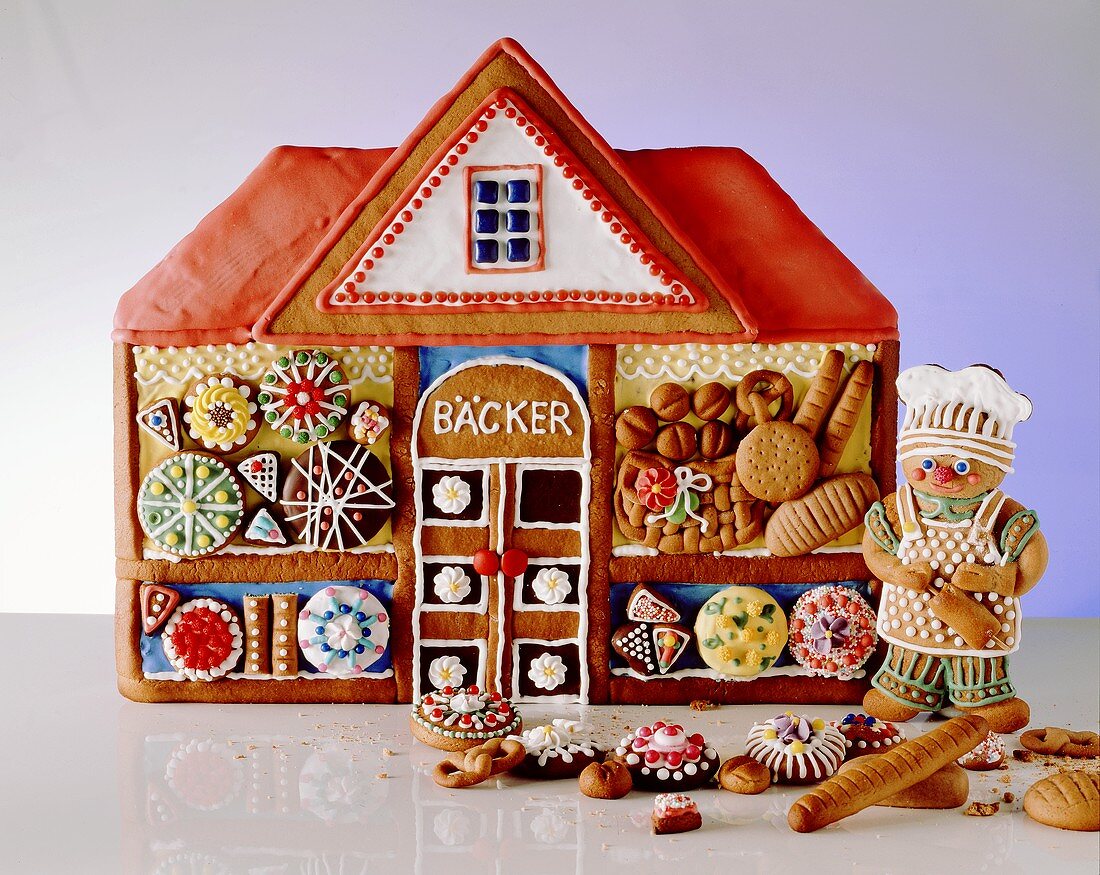Decorated Gingerbread House with Assorted Gingerbread Cookies
