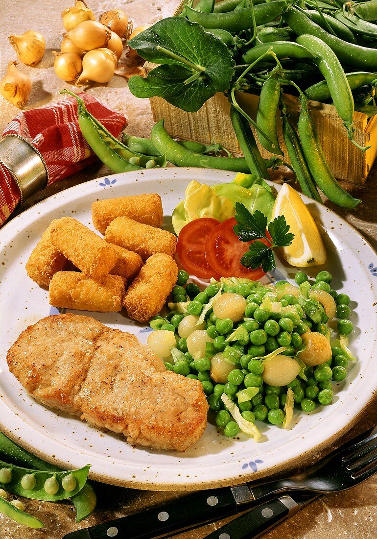 Veal steak with peas and onions and croquettes