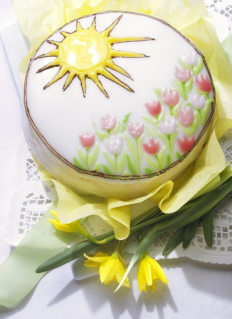 Decorated spring cake with iced tulips and sun