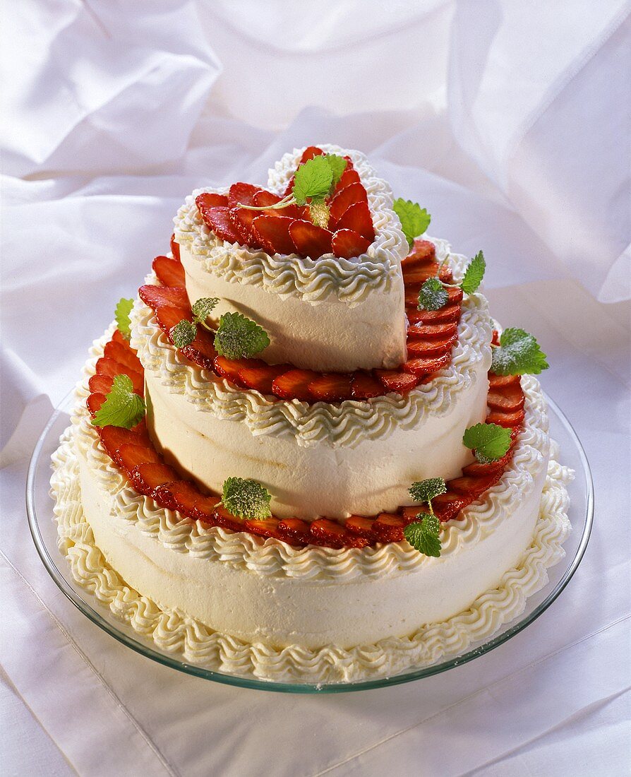 Tiered heart-shaped gateau with strawberries & cream