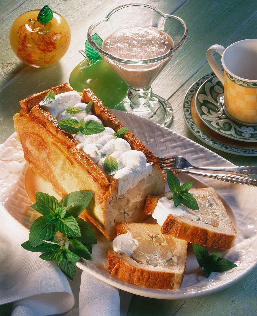 Apple pie with cinnamon sauce, a piece cut, on cake plate