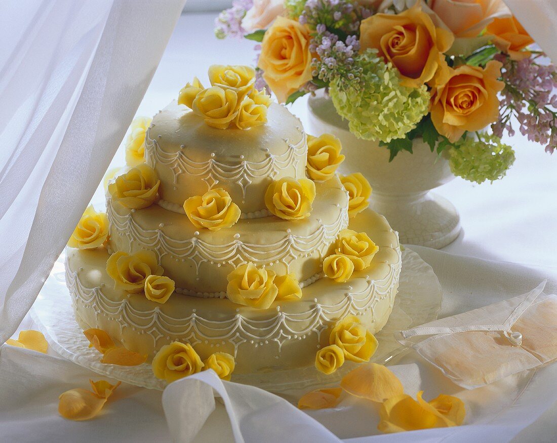 Tiered wedding cake decorated with marzipan roses