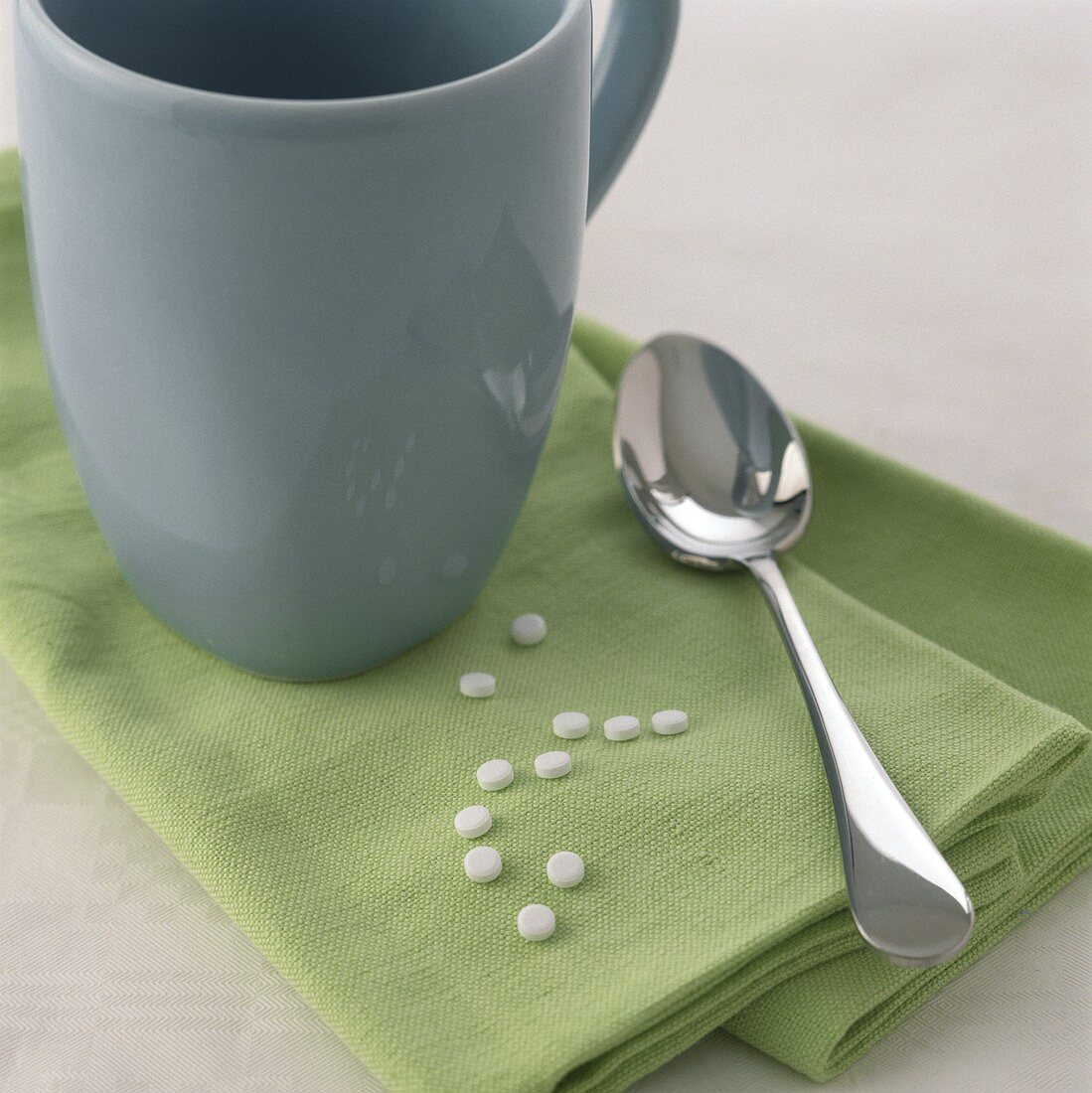 Sweetening tablets with cup and spoon