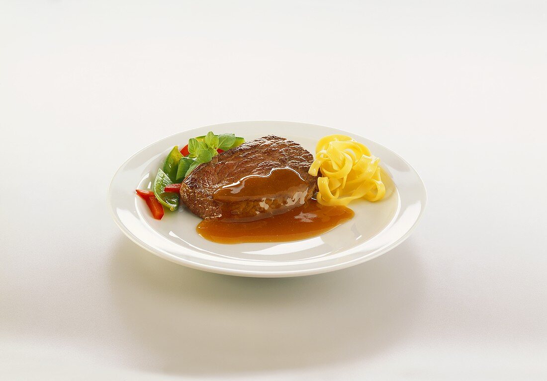 Fillet steak with gravy and ribbon pasta