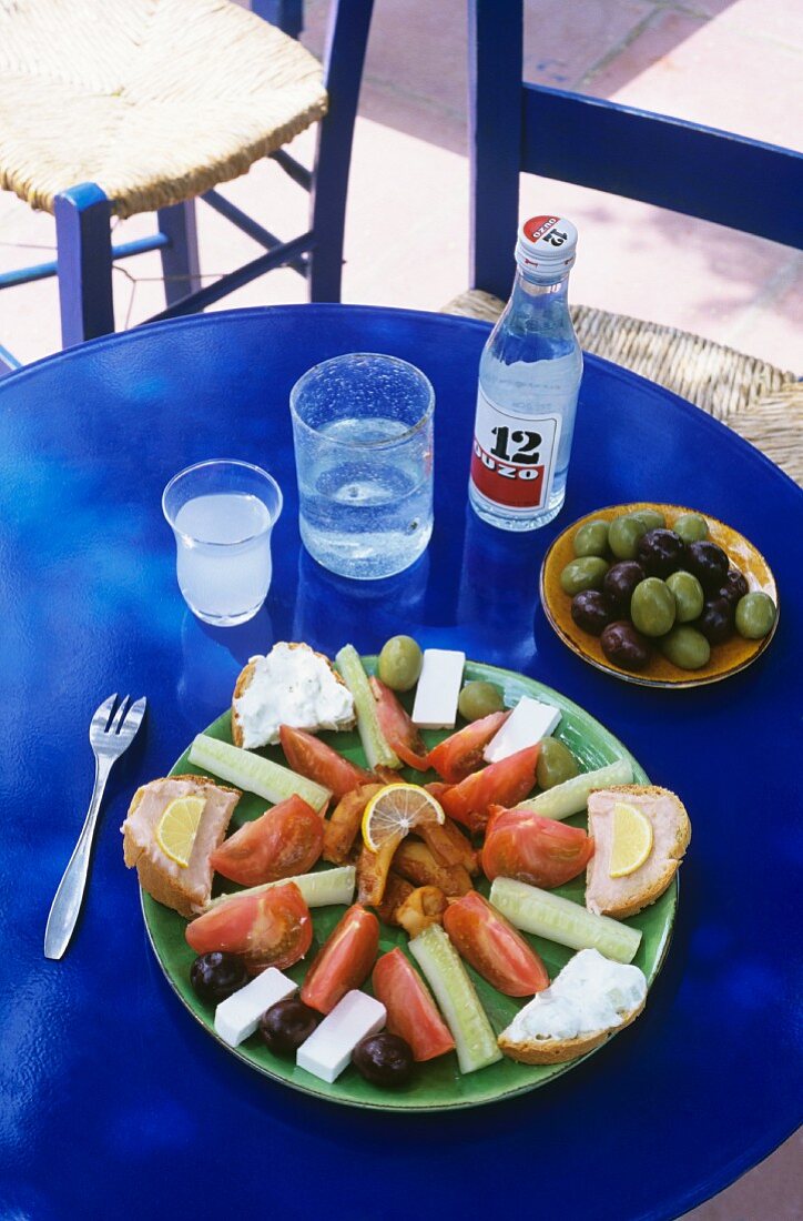 Plate of Greek appetisers and ouzo