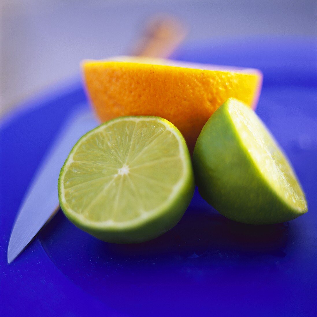 Two lime halves and half an orange