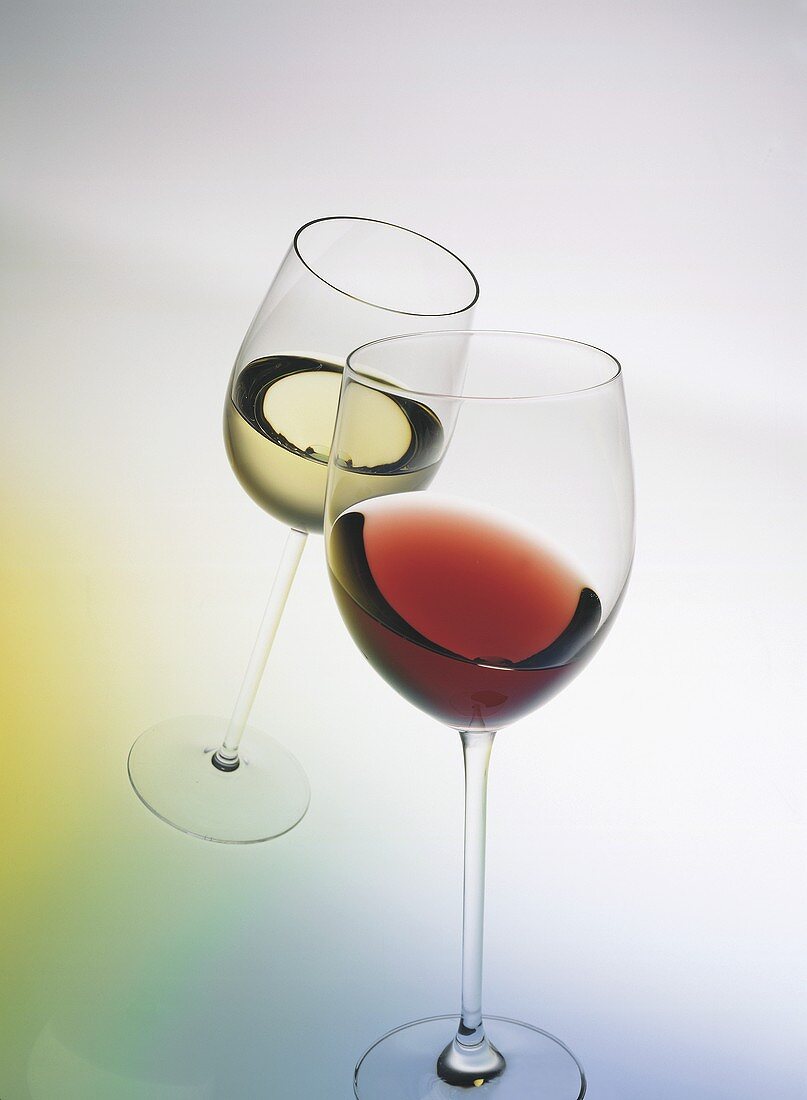 Clinking glasses: a glass of red and a glass of white wine 