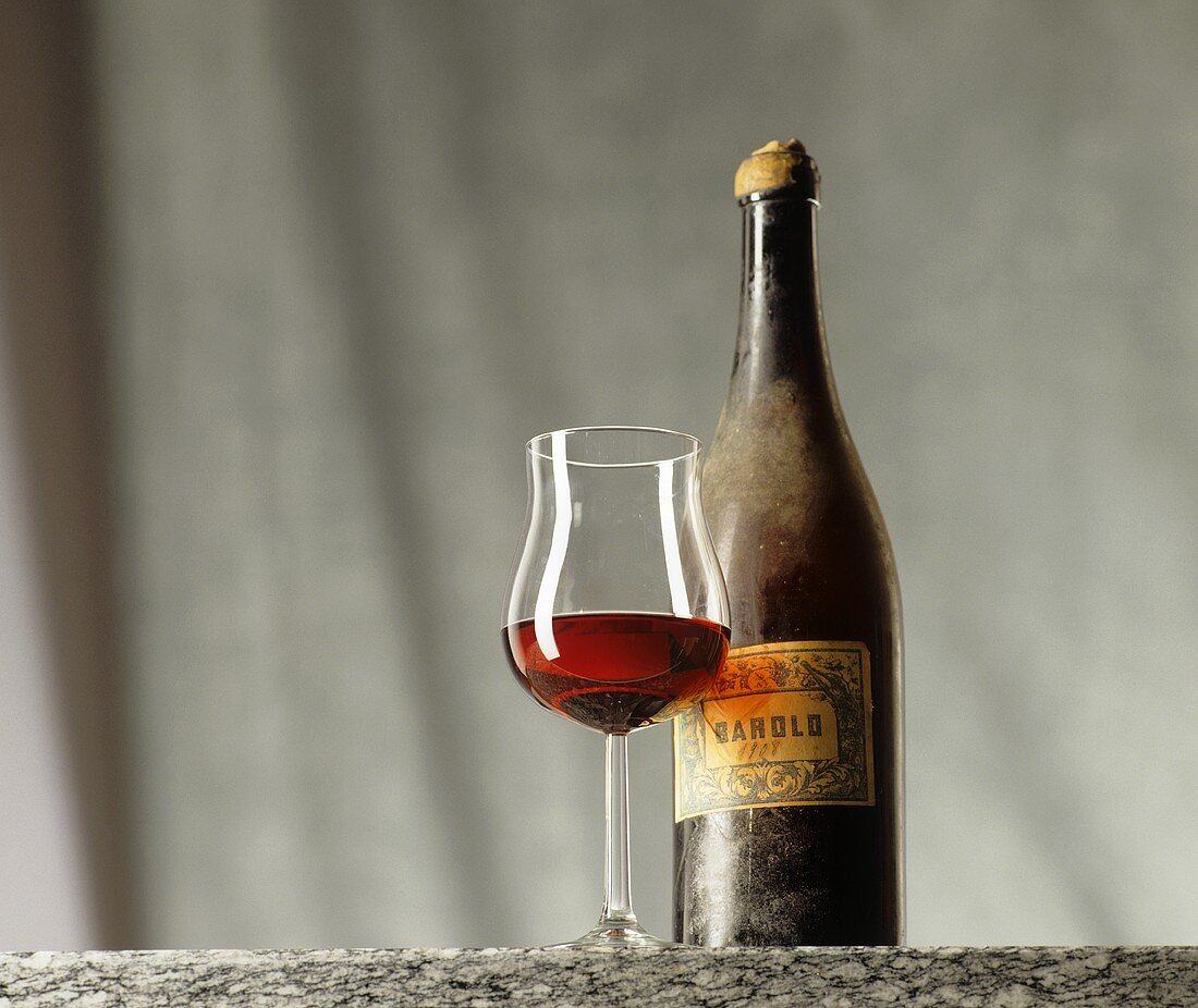 A bottle of Barolo (1908) with filled glass