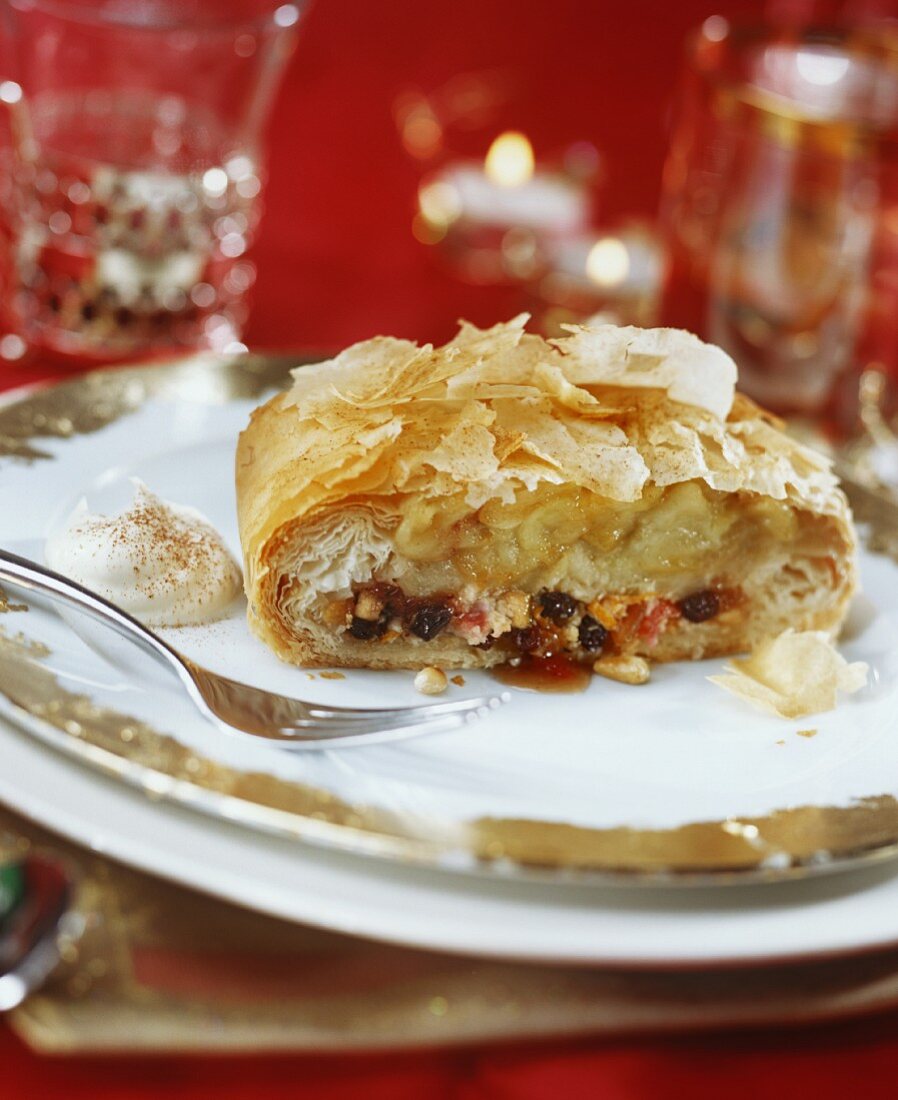 A piece of marzipan apple strudel on festive plate