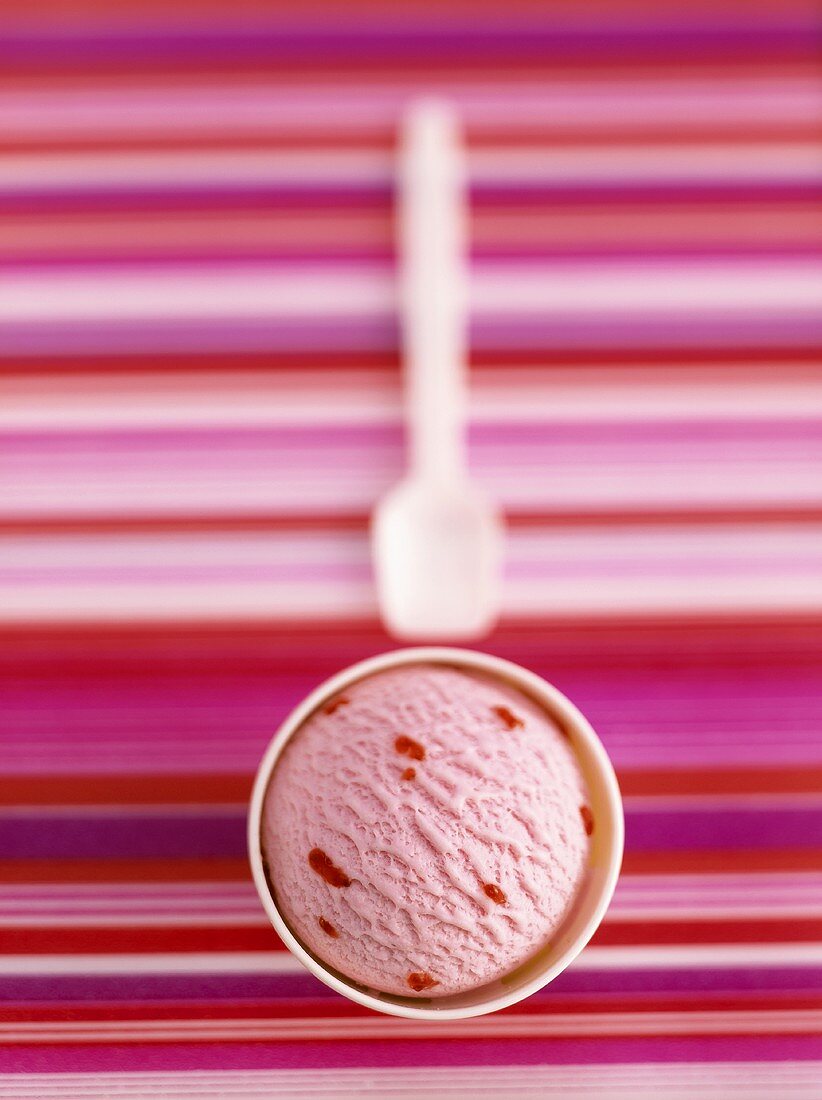 Strawberry ice cream in cardboard tub