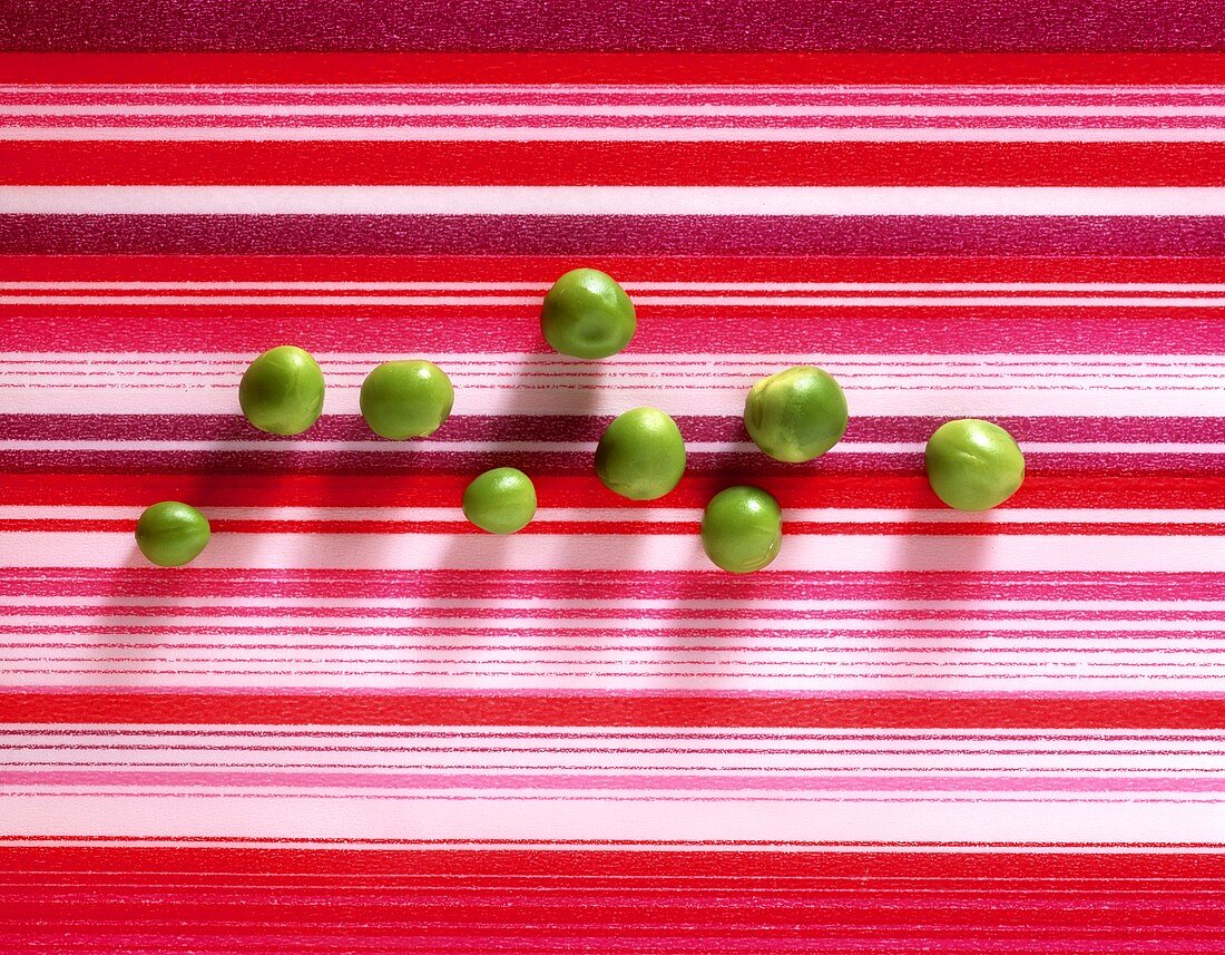 Shelled peas on striped background