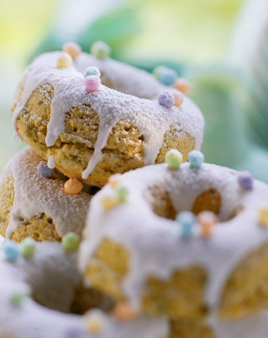 Pistachio cookies with icing and coloured sugar pearls