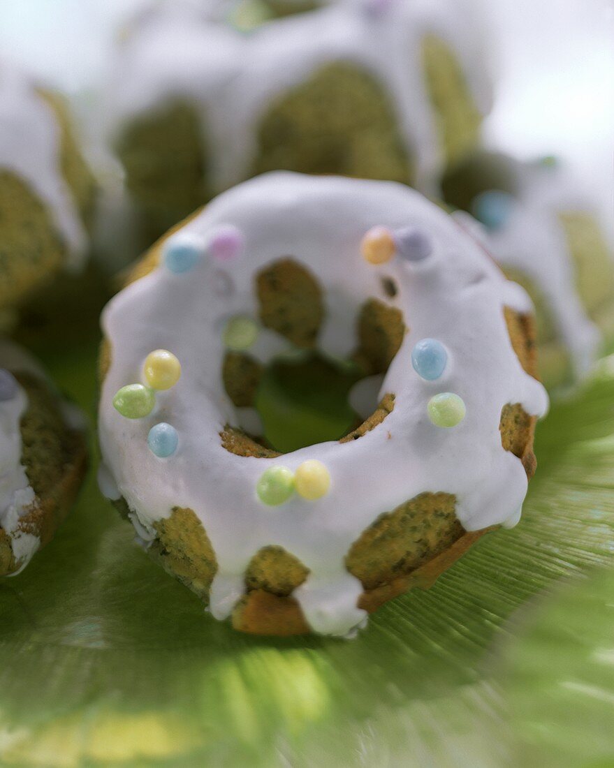 Pistachio cookies with icing and coloured sugar pearls