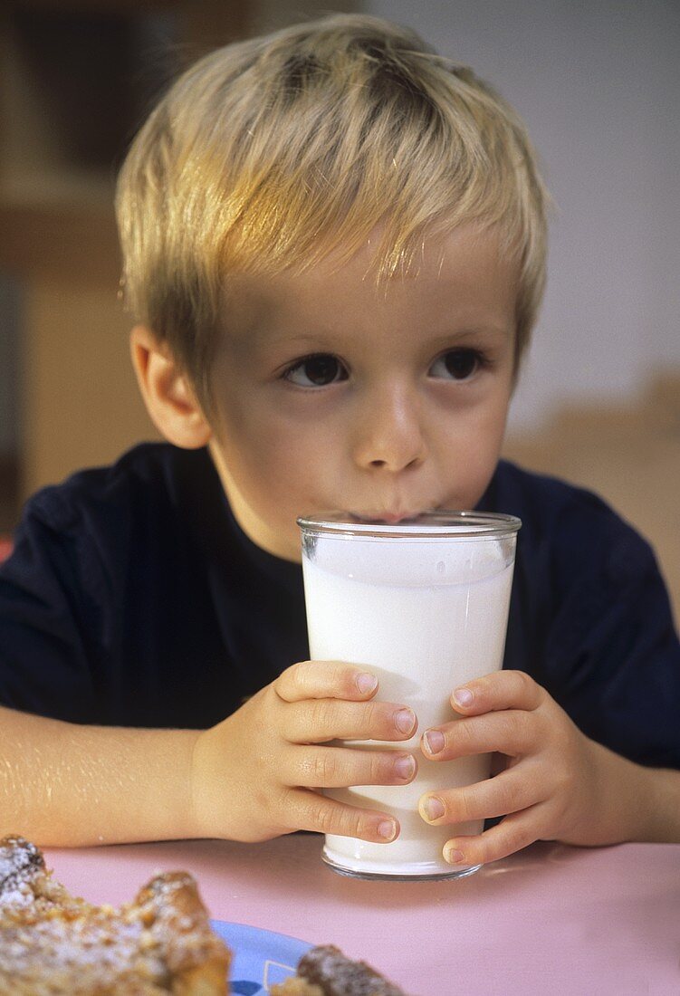 Small boy with a glass of milk