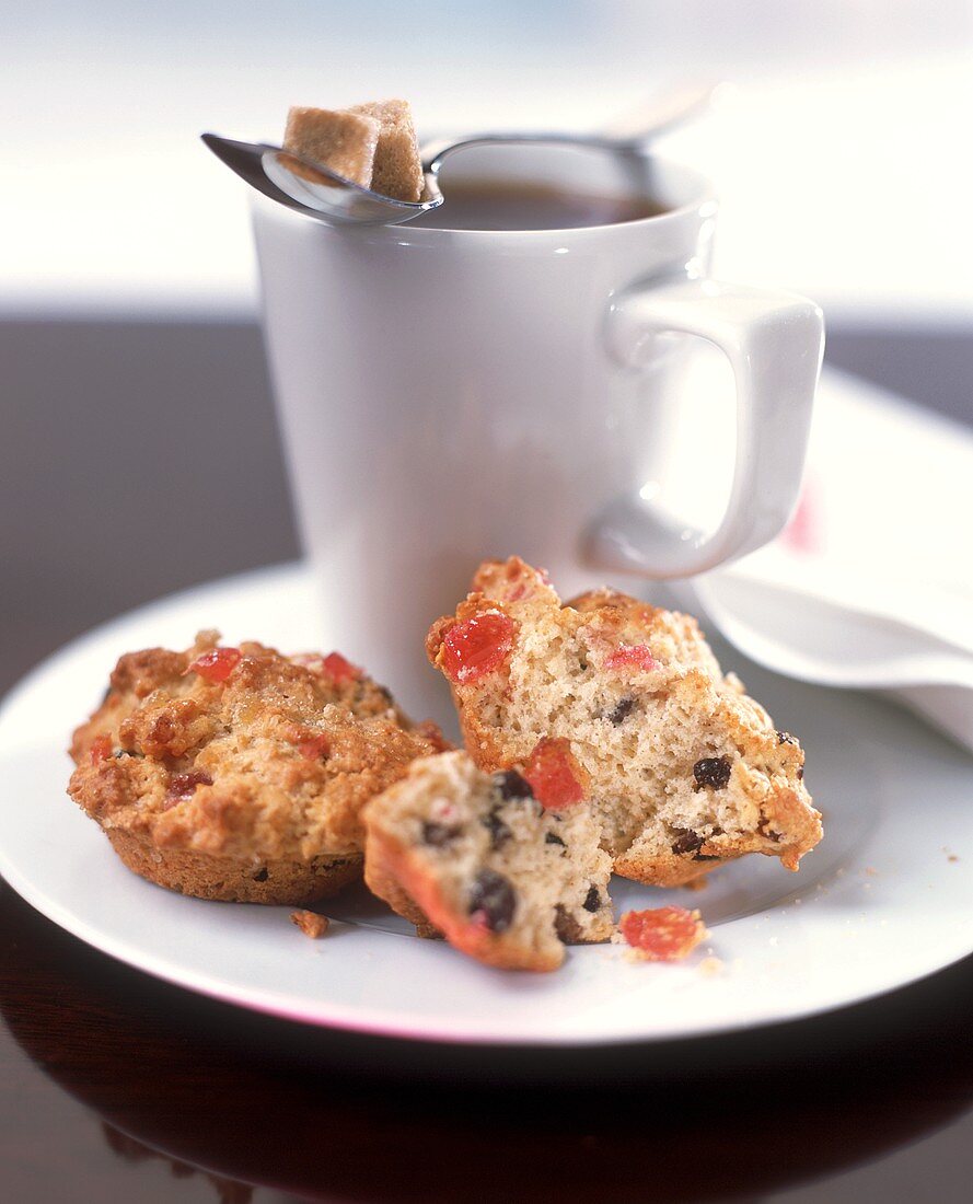 Two fruit muffins and cup of coffee