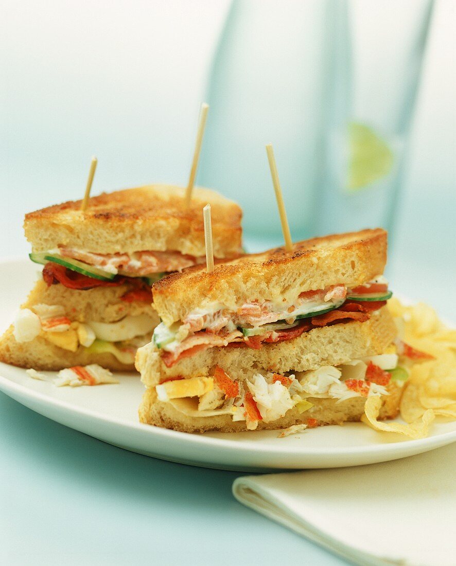Toasted sandwiches with crab, bacon, vegetables