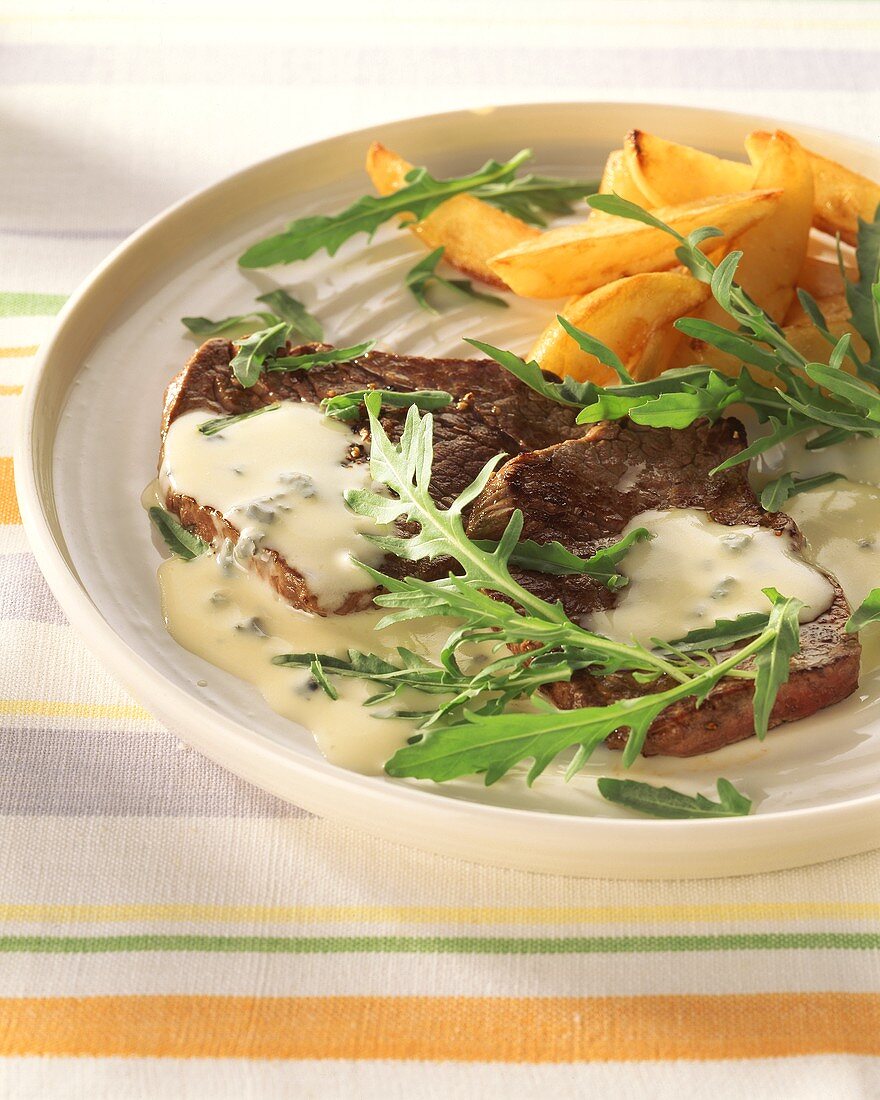Beefsteaks with gorgonzola sauce, rocket & potato wedges